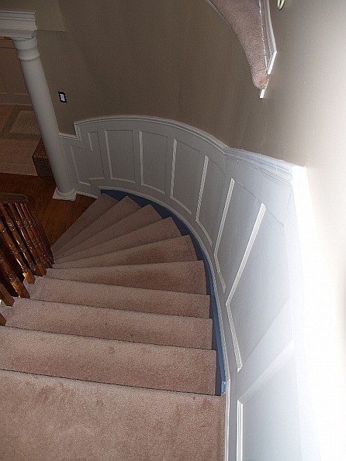 White flexible wainscoting on painted wall along stairs