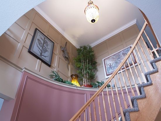 A double recessed panelled accent wall on top of stairs