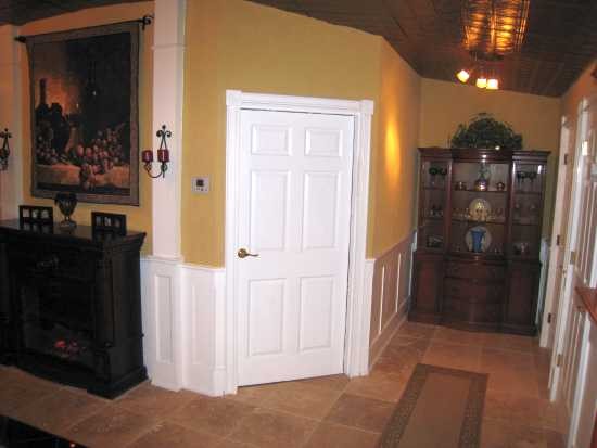 Flat panel wainscoting installed in room and hallway