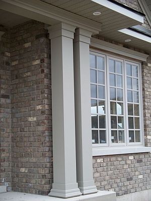 Two painted non-tapered PVC columns next to each other on front porch