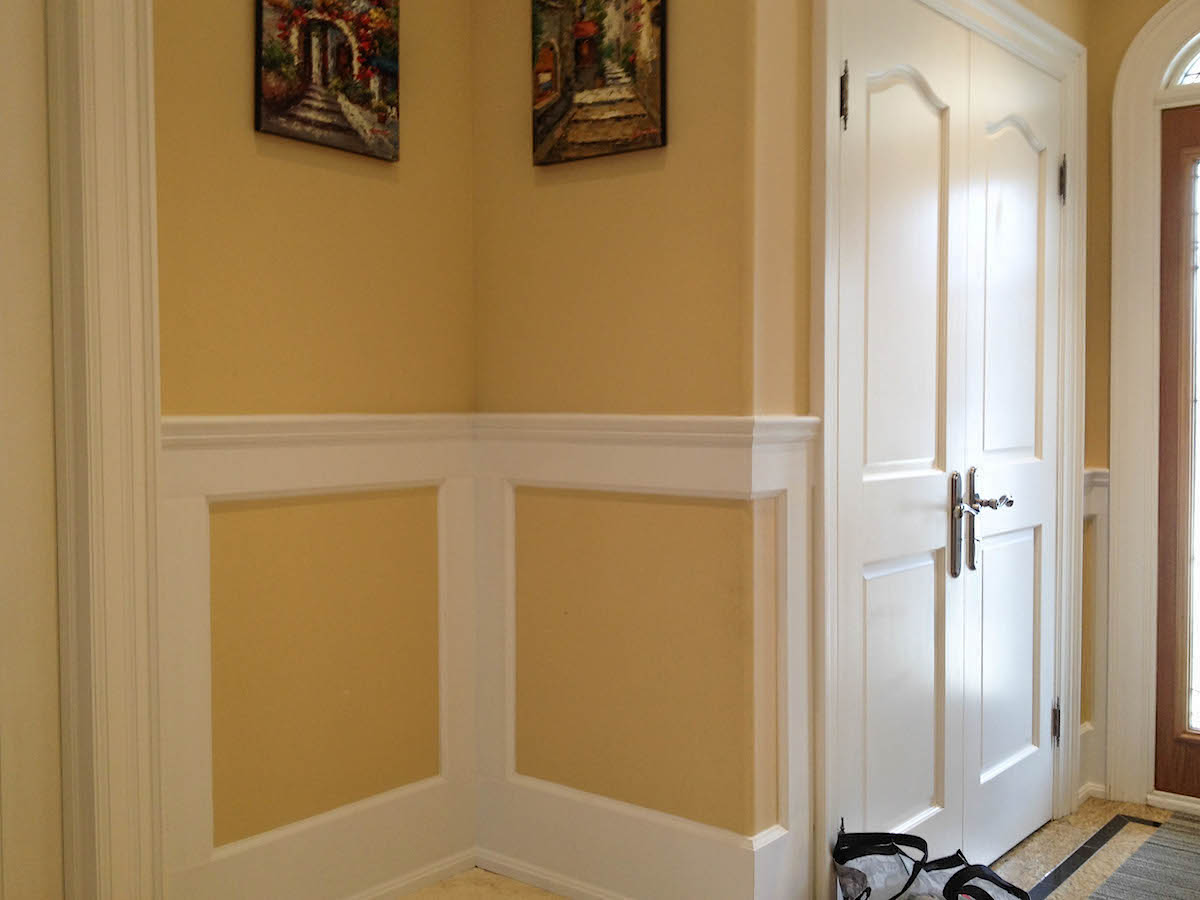 Wainscoting with panels that are painted the same colour as the wall above it