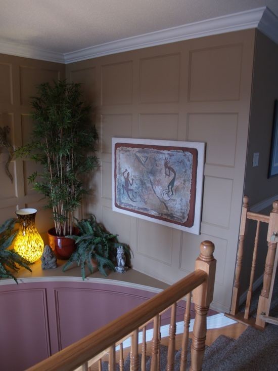 Painted panelled wainscoting creating an accent wall around stairs