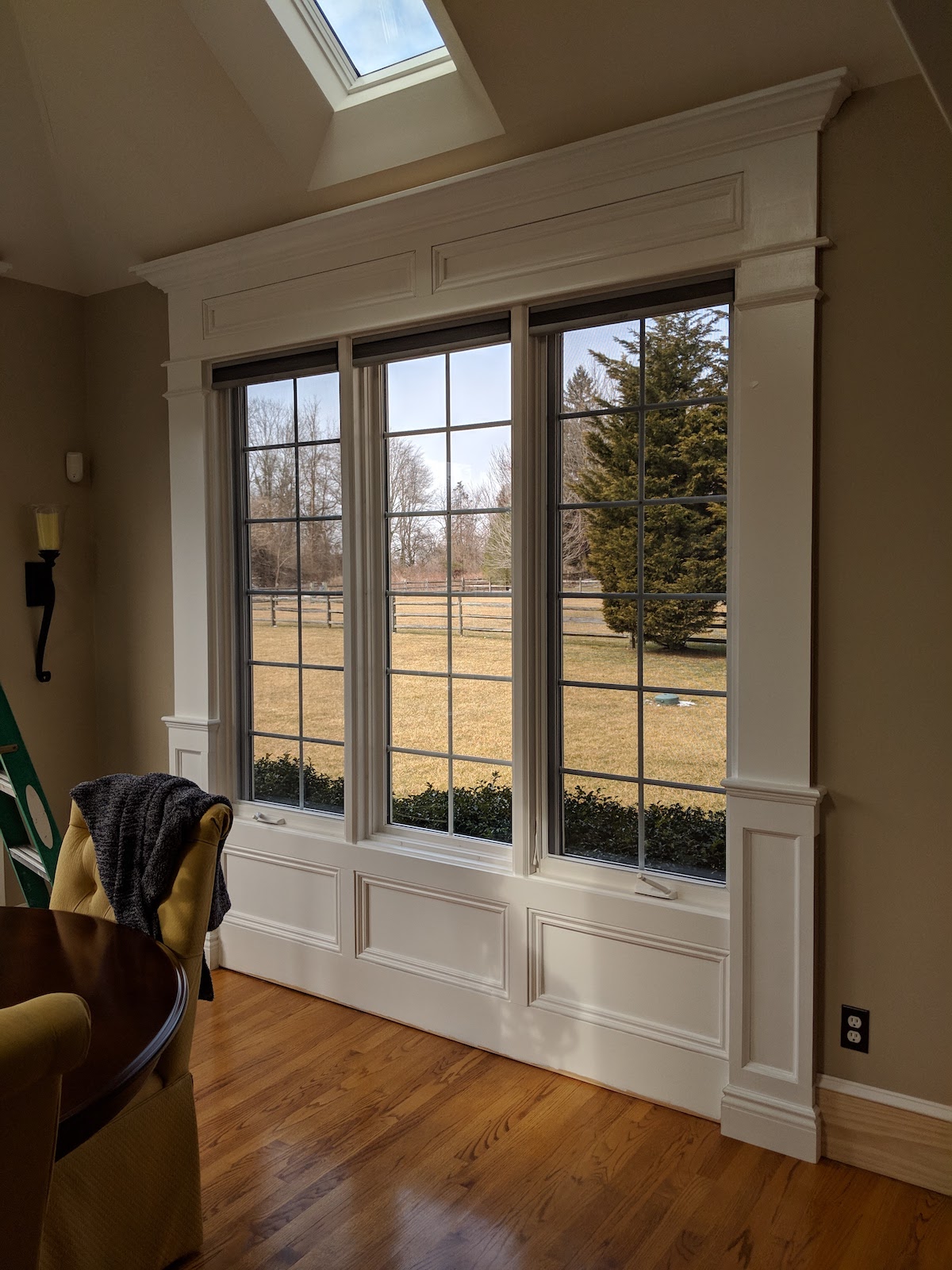 Panelled pilasters used to frame large window in dining room