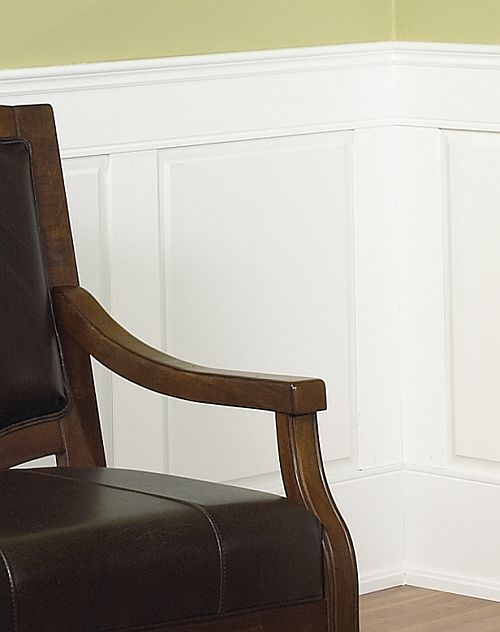 White raised panel wainscoting behind a chair