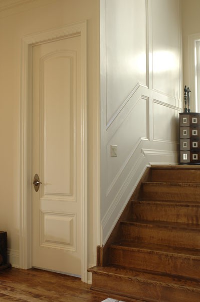 Recessed Panelled wainscoting and accent wall alongside steps