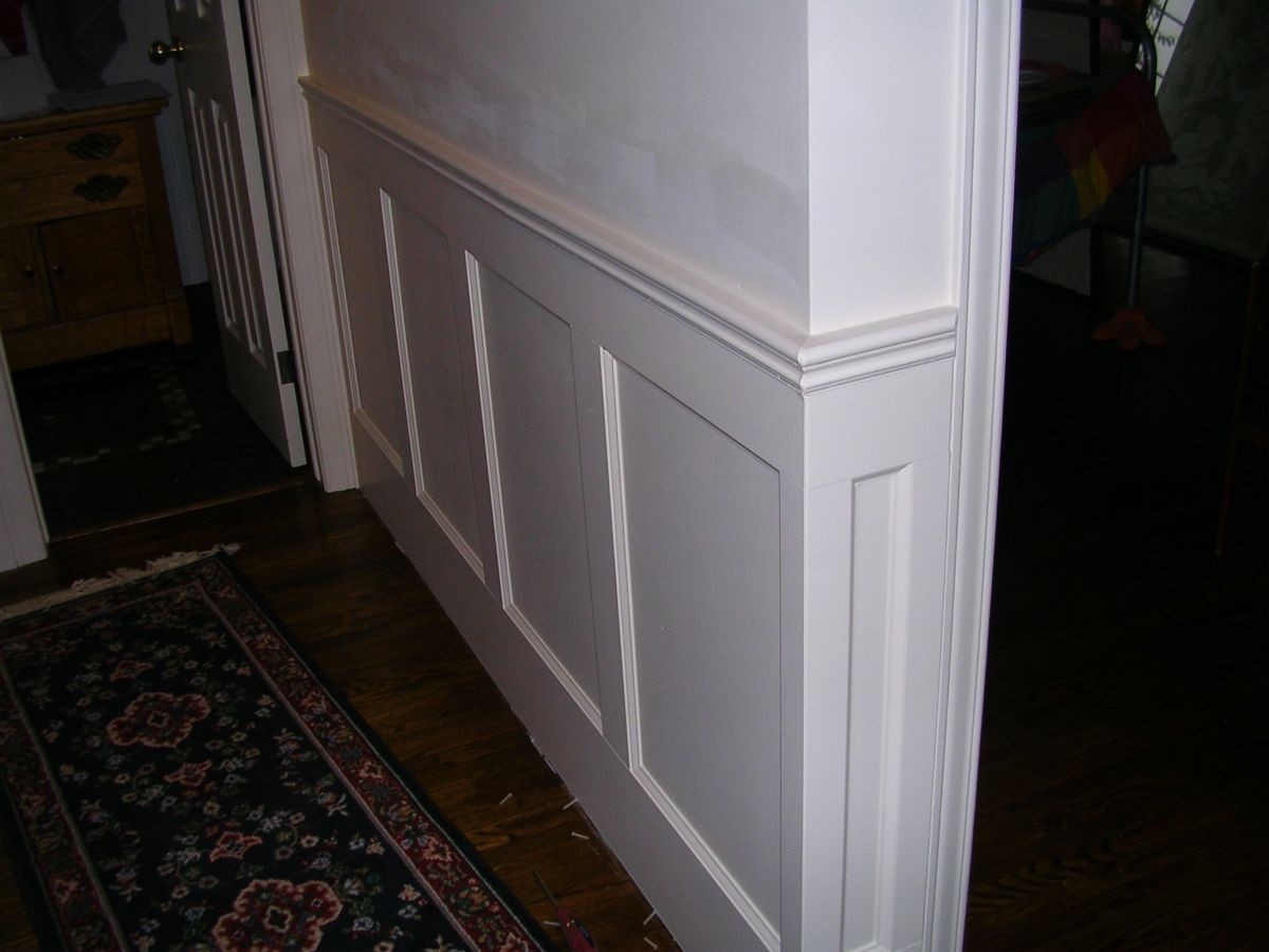An angled side look at the recessed panelled wainscoting applied on a wall