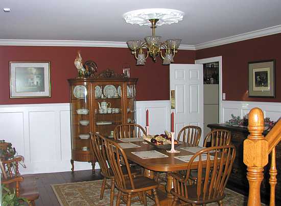 Tall recessed panelled wainscoting all around a dining room
