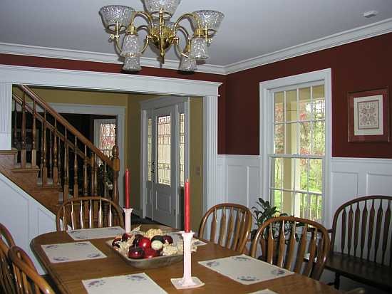 Tall recessed wainscoting in dining room with crown moulding