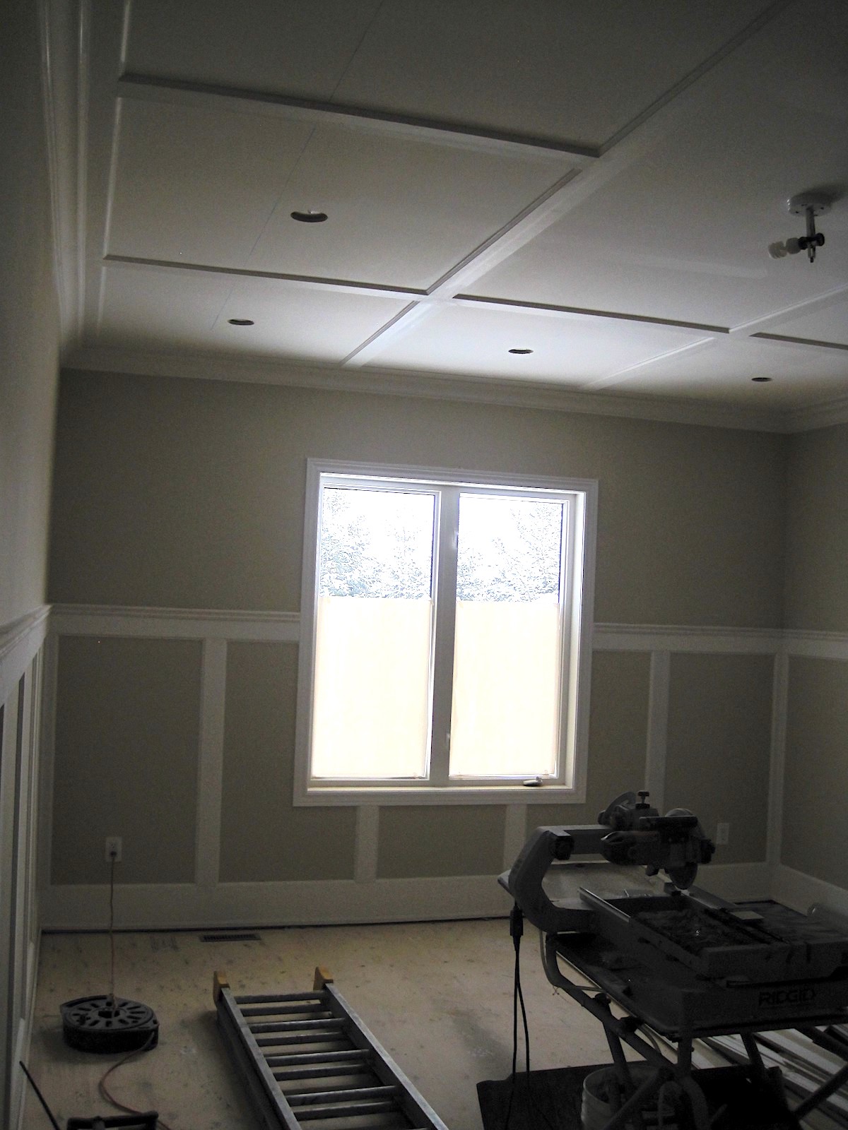 Tall wainscoting without panels being installed in a room
