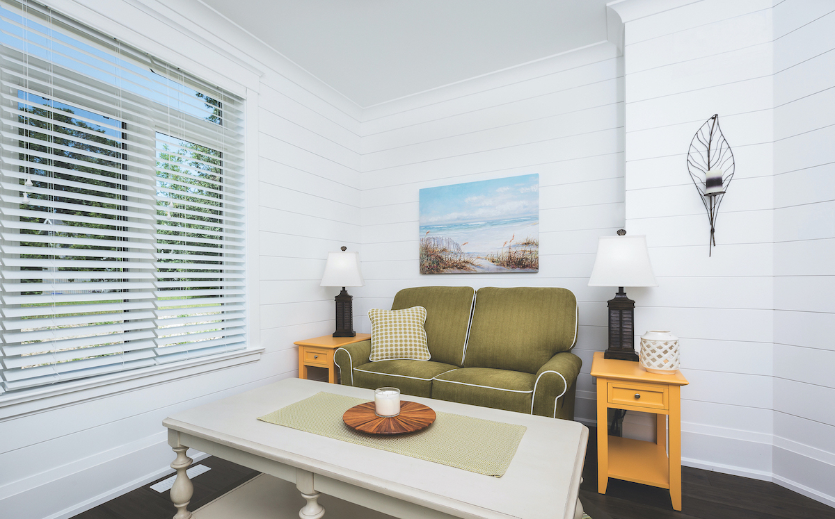 White tongue and groove beadboard style planks on the walls of a living room