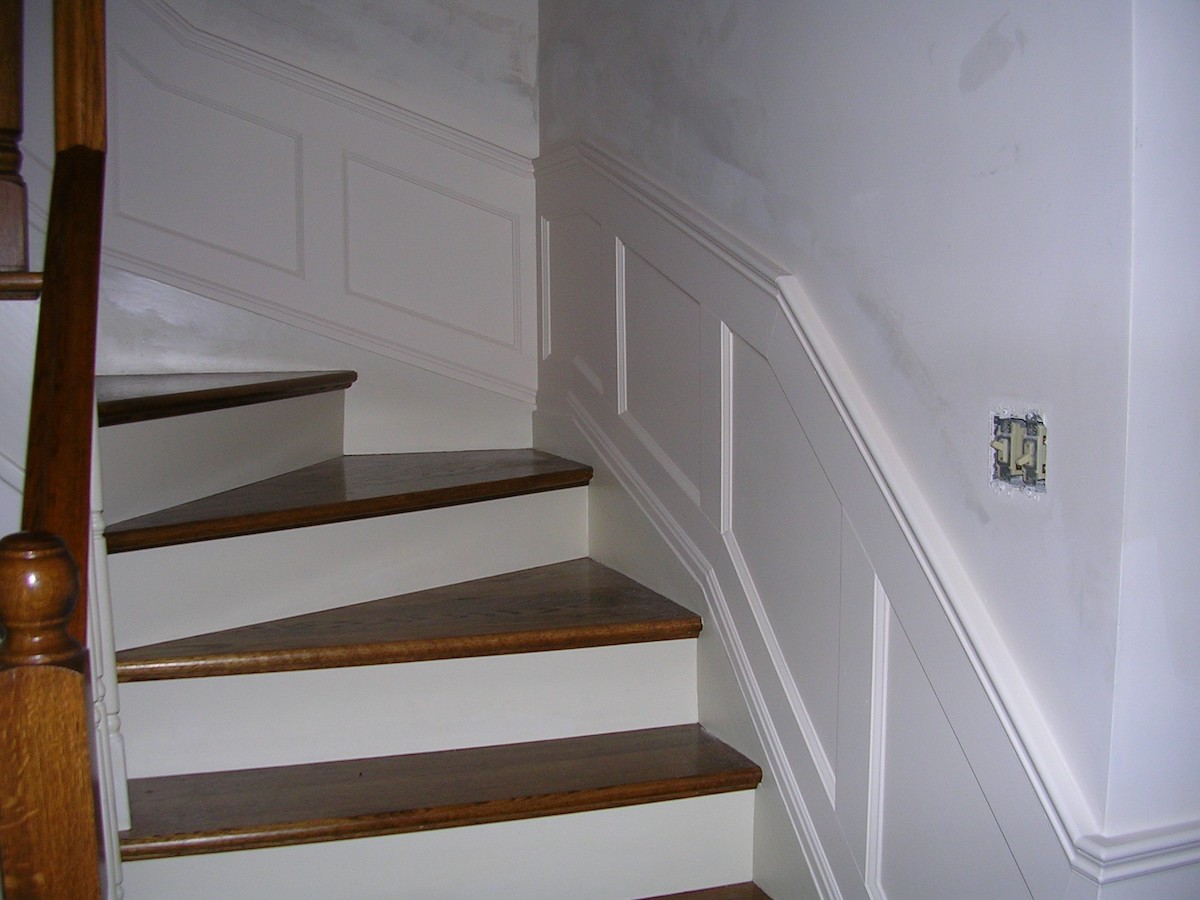 Recessed panelled wainscoting going up a staircase
