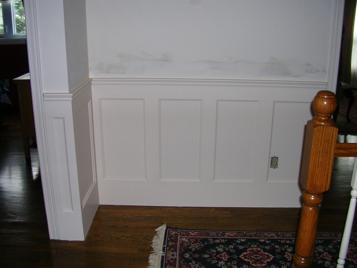 White recessed panelled wainscoting on a white wall
