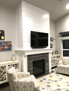 Shiplap planks used to highlight a fireplace in a room