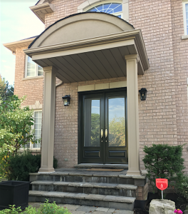 Square recessed columns framing front entrance of home