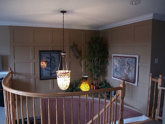A look at two accent walls with wainscoting above a stairwell