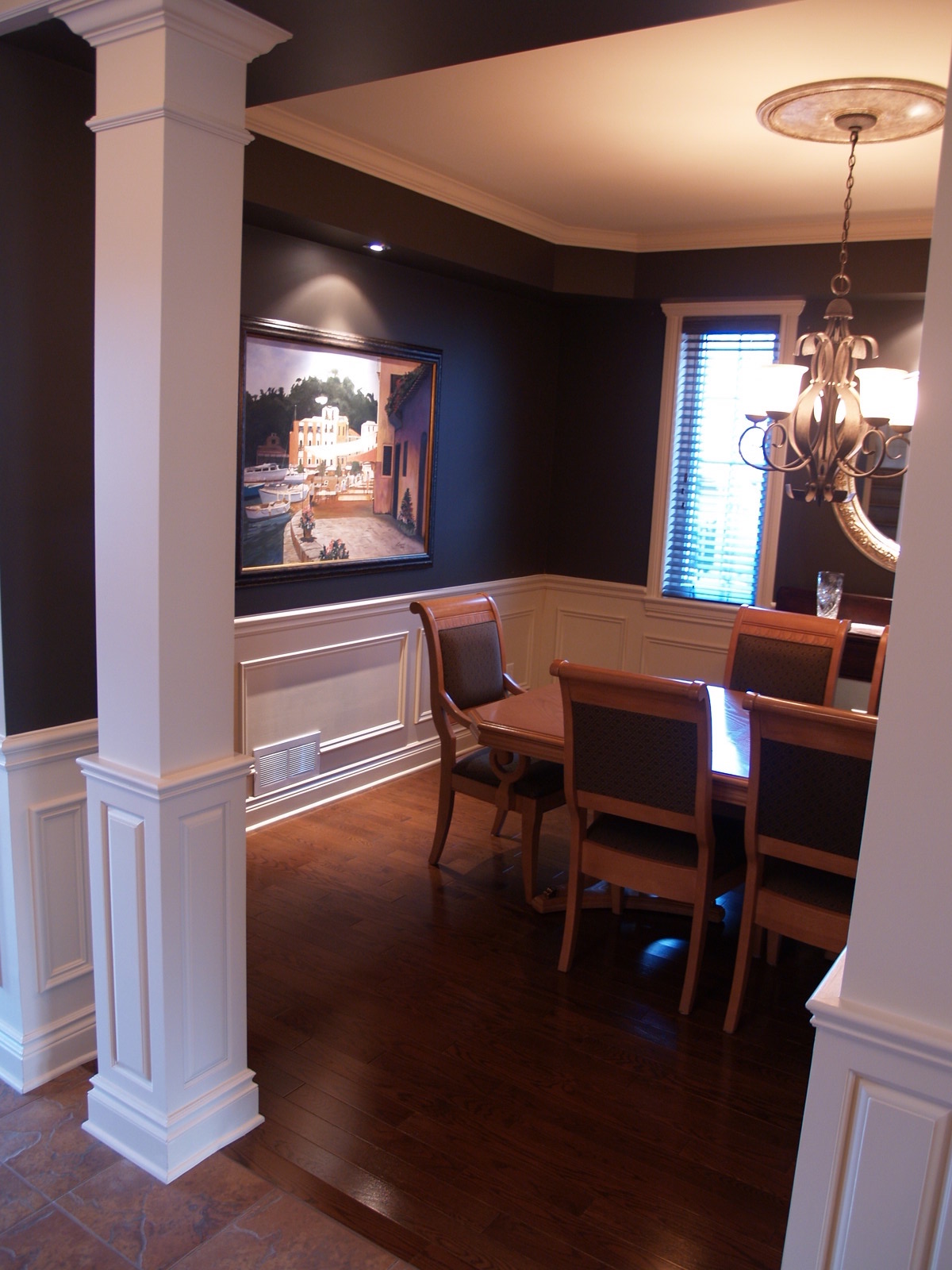 White painted interior square columns that match wainscoting of room