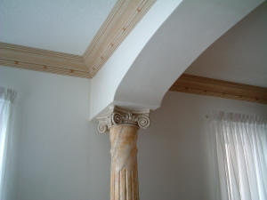 Interior rough sawn fluted wood columns with ionic style capital